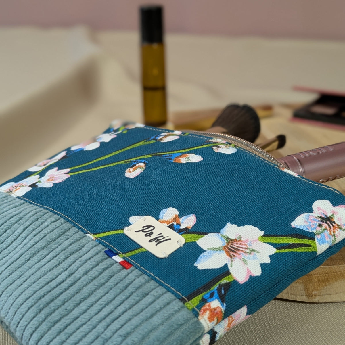 Sa taille est idéale pour être glissée dans un sac. Zoom sur le motif fleurs amandiers sur fond bleu du coton imprimé.